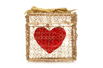 Red heart in a golden gift box