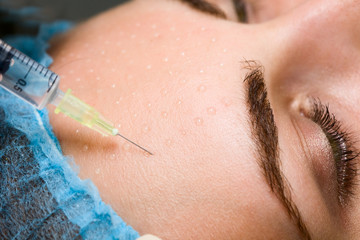 Cosmetic injection to woman's face