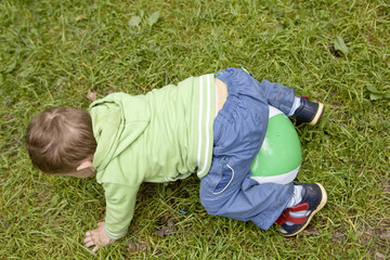 little cute boy playing with ball on playground