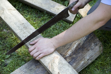 man saw wooden board