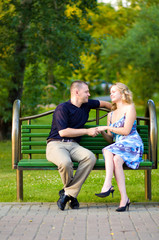 Couple in love sitting at a bench