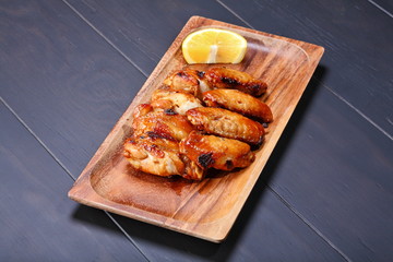 Grilled chicken wings served on wooden board