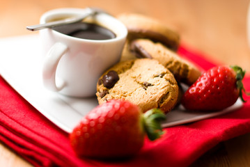 Coffee with cookies and strawberries
