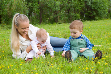 mother with children on meadow .