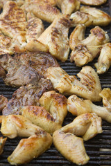 Wings and pork on grill