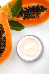 Face cream and fresh papaya