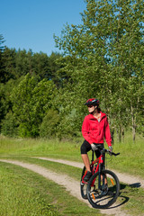 Young woman with mountain bike in the nature