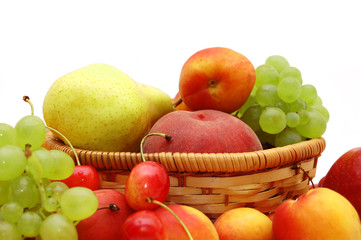 Naklejka na ściany i meble Fresh fruit in a wattled basket on a white background