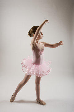 young ballerina pracicing in pink tutu