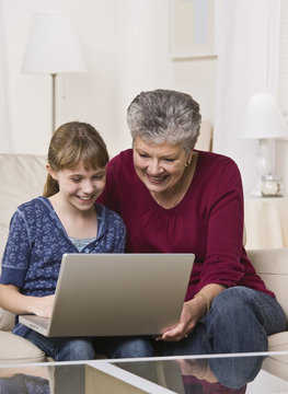 Grandmother and Granddaughter Using Laptop