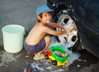 Child washing car and toy car
