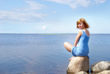 Woman on the shore stone