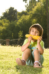 Girl eating corn