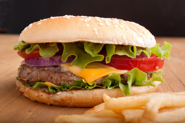 cheeseburger and french fries on a wooden table