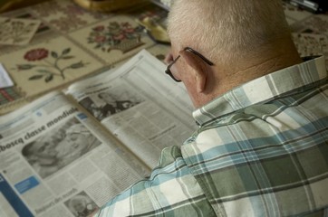 personne agée lisant le journal
