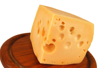 big chunk of yellow cheese on wood plate