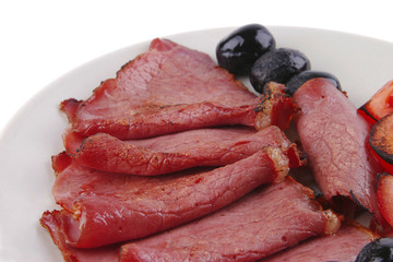 sliced served sausage with raw tomato