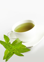 cup of mint tea and fresh leaves