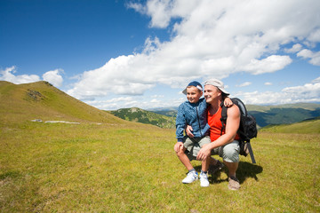 Naklejka premium Father and son hiking in the mountains
