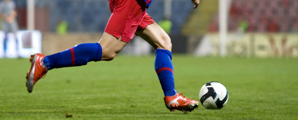 Soccer player running for the ball