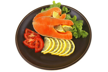 two salmon steak on dark dish