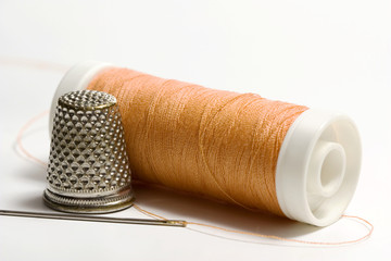 Orange sewing thread needle and thimble