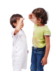 Two children measuring their height