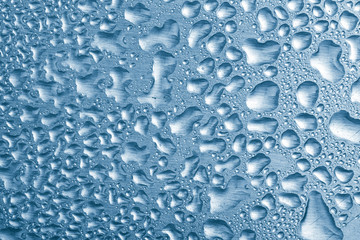 blue water drops over brushed metal background