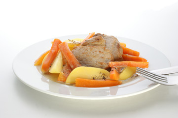 pork chop with carrot and potato on a plate