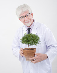 senior scientist holding plant