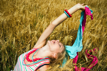 Young woman stretching up in a summer field