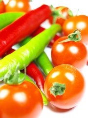 Red and green chilli peppers with cherrys tomatoes