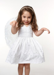 Naklejka premium Little Angel Child in pure white dress and angel wings