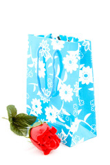 empty paper shopping bag with handles with red rose isolated