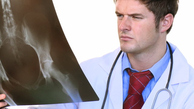 Attractive doctor studying an x-ray footage