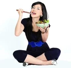 Poster Young asian girl eating salad © Isaxar