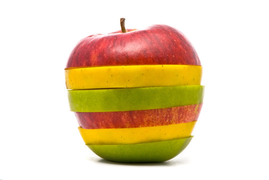 Sliced red, yellow and green apples on studio white