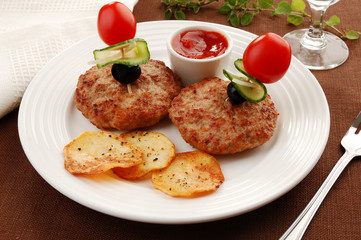 Fried steaks with chips and vegetable salad