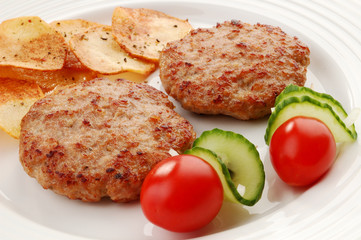 Fried steaks with chips and vegetable salad