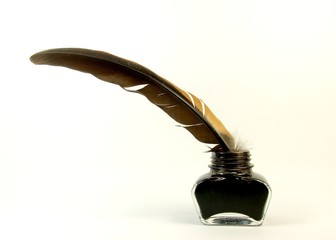 Inkwell with quill on the white background