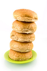 Brown bread stacked on green plate