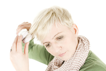 Young woman with hair iron