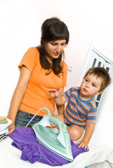 Mother and son ironing