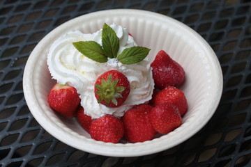 strawberries with cream, decorated with mint leaves