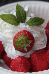 strawberries with cream, decorated with mint leaves