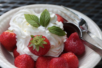 strawberries with cream, decorated with mint leaves