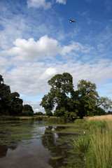 Light Aircraft and Blue Skies Over Charlecote Park Lake