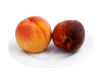 Fototapeta na wymiar Ripe peaches in a porcelain plate on a white background
