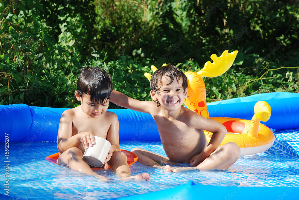 Wall mural Children activities on swiming pool in summer