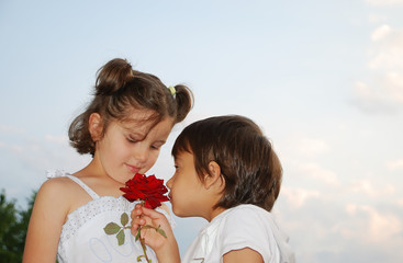 Beautiful scene of a boy and girl with rose